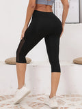 Legging Court Semi Transparent Femme noir avec empiècements transparents, confortable et stylé pour sport et détente.