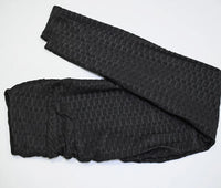 Legging Anti Cellulite XXL noir plié avec texture, confortable et sculptant pour un effet amincissant.