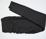 Legging Anti Cellulite XXL noir plié avec texture, confortable et sculptant pour un effet amincissant.