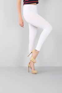 Femme de profil qui porte un legging gainant grande taille blanc