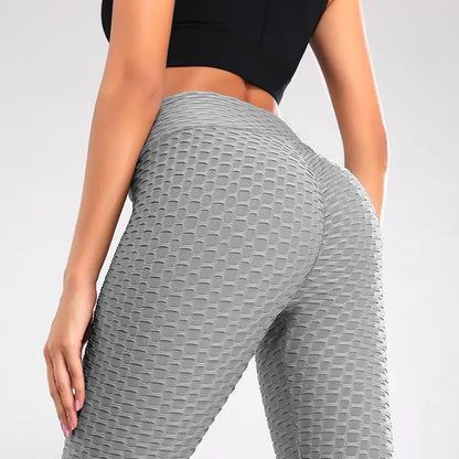 Femme portant le Legging Anti Cellulite France gris texturé, mettant en valeur les formes et silhouette tonique.
