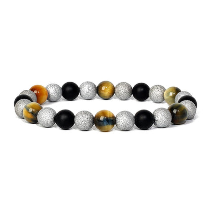 Bracelet magnetique pour maigrir homme en perles argent, noires et oeil de tigre, elegamment dispose sur fond blanc
