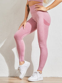 Femme plan 3/4 qui porte un legging gainant push up rose